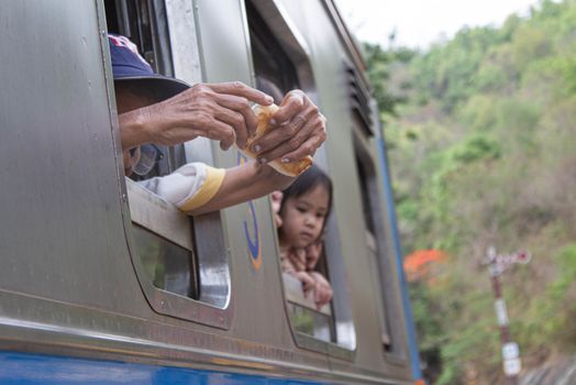 Passengers sitting on The vintage diesel engine train at Khuntan, Lamphun province to travel to their destination.