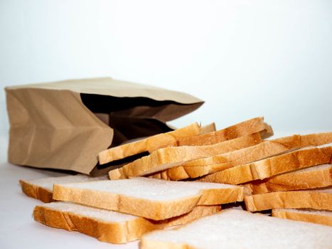 Bread full sliced in paper bag isolated on white background.