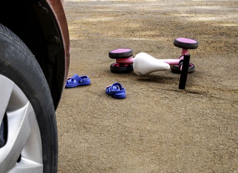 Close-up of a bicycle for children accident behind the vehicle on the street. Car Accident