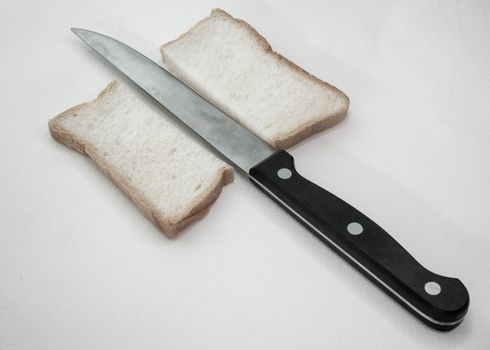 Sliced Bread with knife on white background.