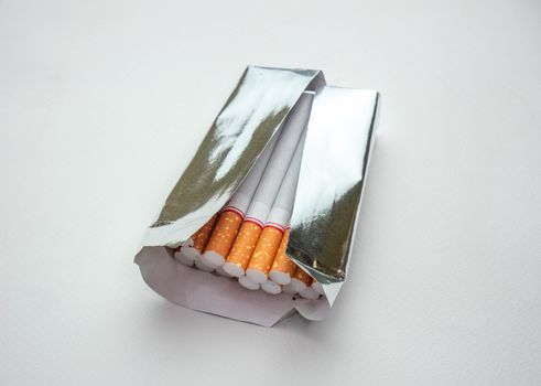 World No Tobacco Day; Open pack of cigarette tobacco in foil isolated on white background.