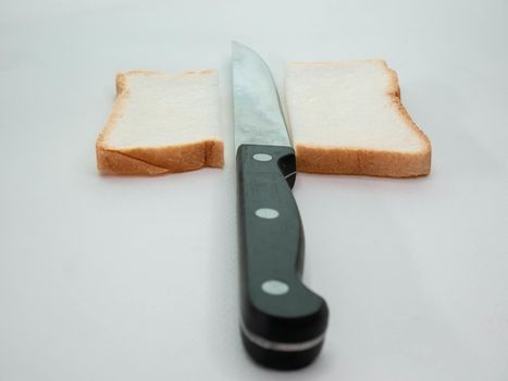 Sliced Bread with knife on white background.