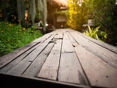 Wooden walkway in the garden with sunlight in the evening.