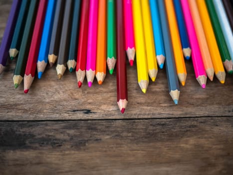 Color pencils place on wooden background with copy place for your text.
