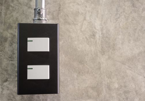 White light switch, turn on or turn off the lights on concrete wall in room.