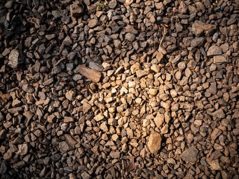 Closeup of many small brown stones as background texture.