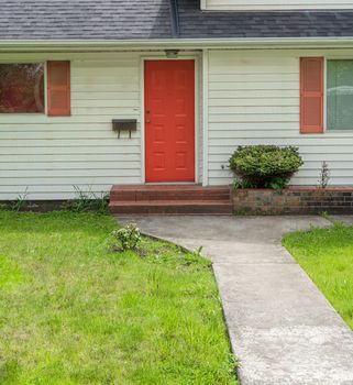 Old house main entrance with red door.