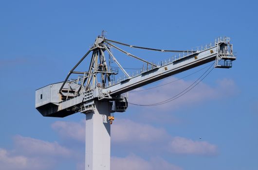 Dockyard Crane. Grey against the blue sky.
