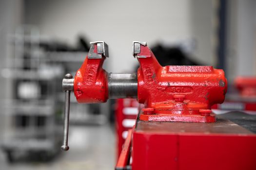 red vise on table in factory.