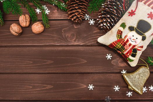 Christmas background Fir branches, cones and nuts on a wooden table. Space for text . View from above. Christmas atmosphere