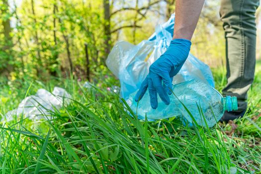 global pollution of the planet with plastic waste. Volunteers help ecology by clearing forests and meadows by collecting waste.