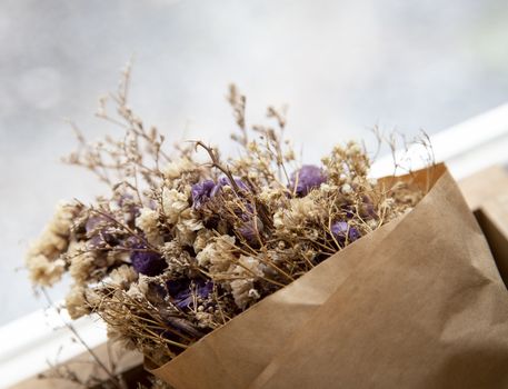 Bouquet of dried flowers in brown paper