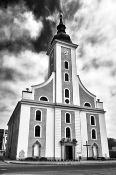 A historic church with a belfry  in the city of Javornik in the Czech Republic, black and white