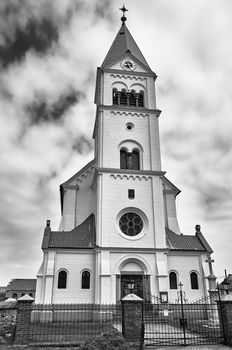 A historic parochial church with a belfry in Poland, black and white