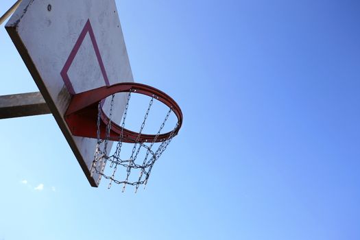 Basketball hoop in front of a blue sky