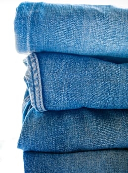 Pile of different blue jeans, fabric texture