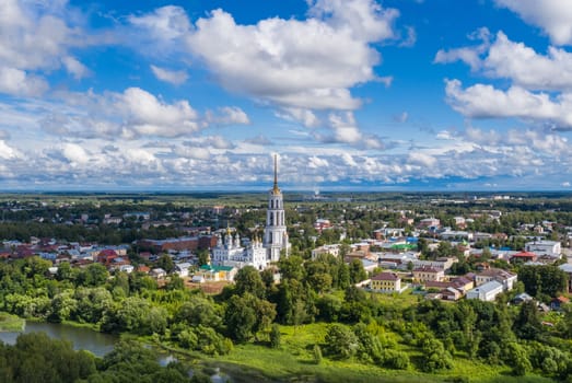streets of a provincial town in Russia with a high bell tower on a sunny summer day, shot from above