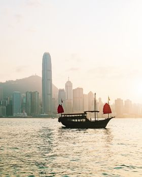 Hong Kong skyline with a traditional boat seen from Kowloon, Hong Kong, China.