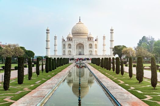 Taj Mahal front view reflected on the reflection pool, an ivory-white marble mausoleum on the south bank of the Yamuna river in Agra, Uttar Pradesh, India. One of the seven wonders of the world.