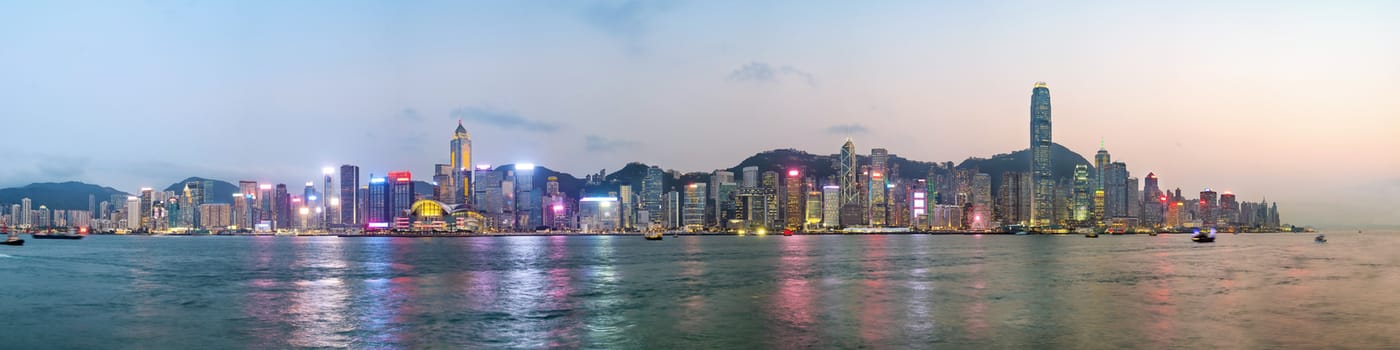 Panorama view of Hong Kong skyline on the evening seen from Kowloon, Hong Kong, China.