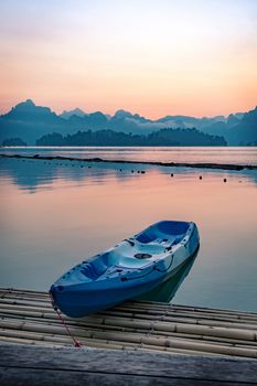 Paddle boat floating in a dam in southern of Thailand in the morning.