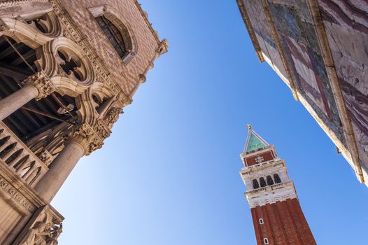 Low angle view of the bell tower in Saint Mark's square and the Doge's Palace as well as part of Saint Mark's basilica