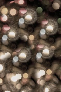 Abstract holiday background with bokeh and lights on a dark background