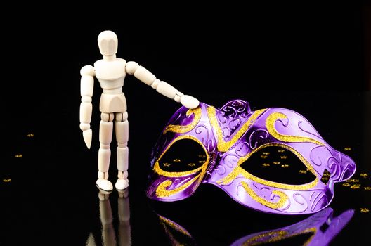 wood dummy with carnival mask in black background