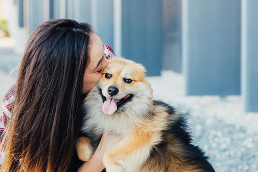 woman kissing dog with copy space for text