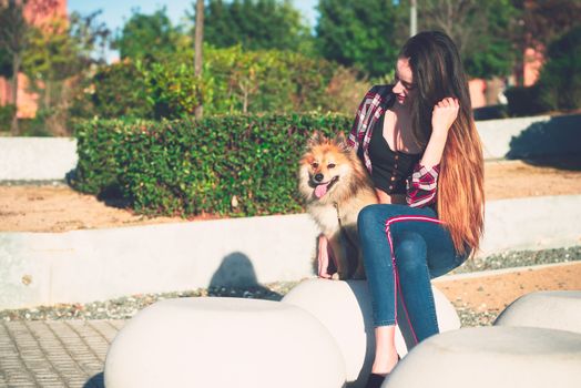 young woman sitting with beautiful dog