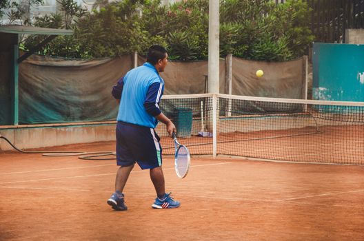 Tennis player with a racket in full match