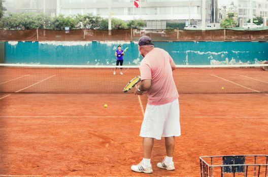 Tennis players with racket in full play