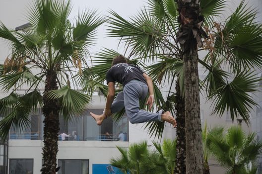 Man on rope jumping and doing balance
