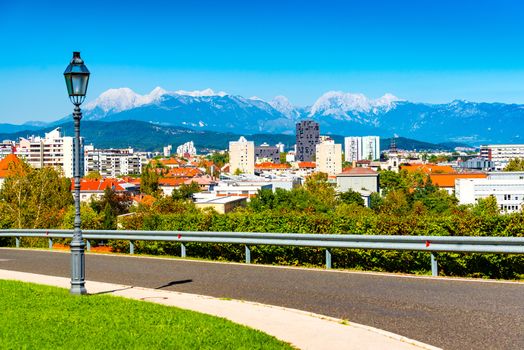 Picturesque cityscape of a European modern city with a beautiful mountain range in the background