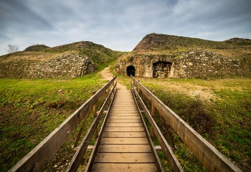 Old wooden bridge and ancient ruins in fortress-town Palmanova, Italy