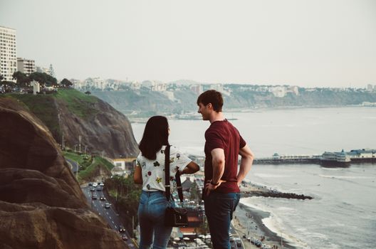 Couple in love talking on the edge of the sea