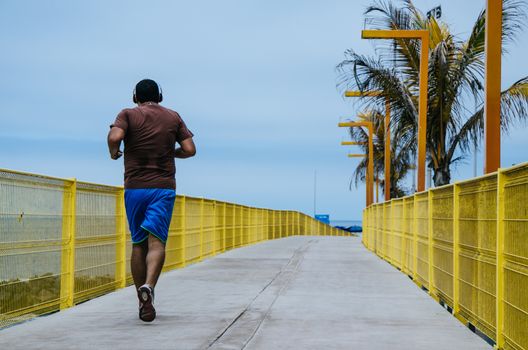 Man running along the coastline of the beach