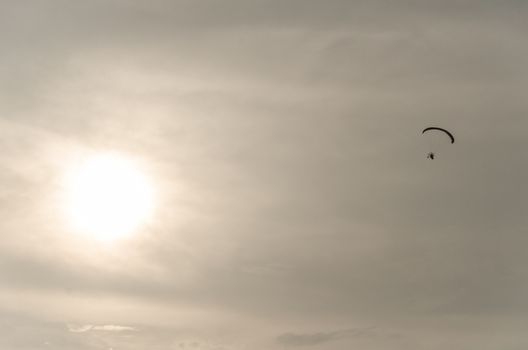 Man flying on a paraglider for a sunny afternoon