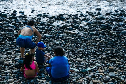 Two women with two children on the beach