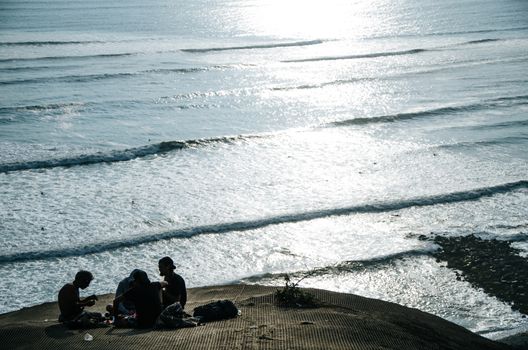 A group of travelers sharing facing the sea