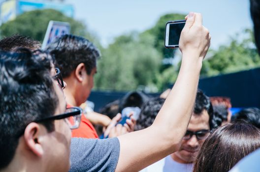 Man with cell phone in hand taking picture