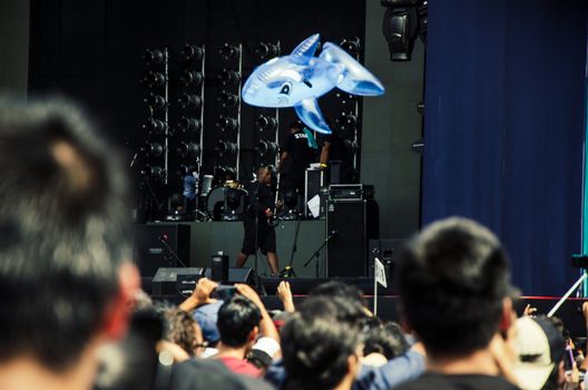 Balloon of a dolphin in the middle of the rock concert