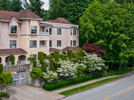 A Perfect Neighbourhood. Italian style low-rise residential building with decorative trees on land terraces