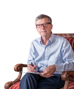 Senior caucasian adult checking a document in hand while seated. He is wearing a pair of glasses and cutout against white