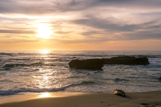 Beautiful colorful sunset over the sea, clouded sky on twilight time and reflection on the sea. in La Jolla, San Diego, California, USA