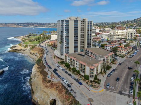 Aerial view of La Jolla coast, San Diego, California. Beach and blue sea with small waves. Hilly seaside of curving coastline along the Pacific.