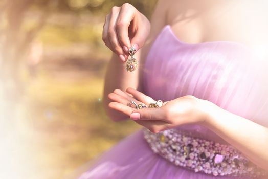 Wedding jewels in female hands close-up. vintage dress. fashion.