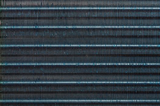 blue hydrophilic coaterd heat radiator - air conditioner evaporator close-up coil texture.