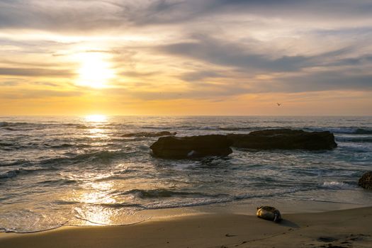 Beautiful colorful sunset over the sea, clouded sky on twilight time and reflection on the sea. in La Jolla, San Diego, California, USA