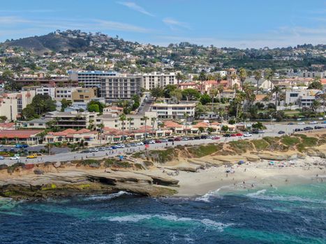 Aerial view of La Jolla coast, San Diego, California. Beach and blue sea with small waves. Hilly seaside of curving coastline along the Pacific.